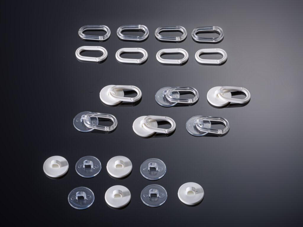 Adhesive buttons for retail display and packaging